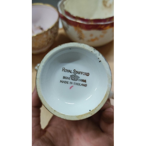 463 - Set of Royal Stafford bone china teacups and saucers detailed with intricate gold and red accents. P... 