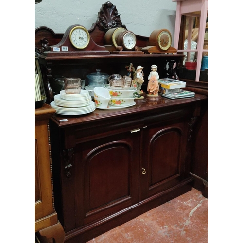 466 - Antique style mahogany sideboard with intricate scrollwork design, includes shelves and cabinets. It... 