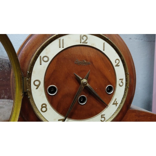 468 - 4 vintage mantel clocks. Made from wood with ornate details. Includes a mid-century Spartan USA 8-da... 