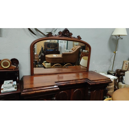 475 - Victorian mahogany sideboard features an intricately carved mirror and panelled doors. The item has ... 