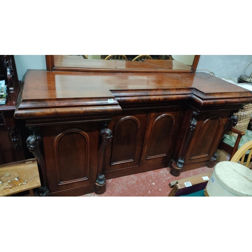 475 - Victorian mahogany sideboard features an intricately carved mirror and panelled doors. The item has ... 