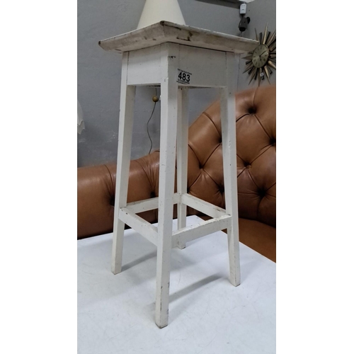 483 - Vintage white-painted wooden stool, featuring a distressed finish and four sturdy legs with crossbar... 