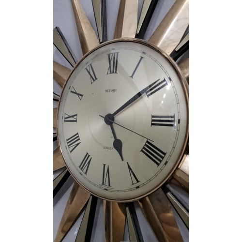 498 - The Metamec Sunburst Wall Clock features a quartz movement with Roman numeral hour markers. This ite... 