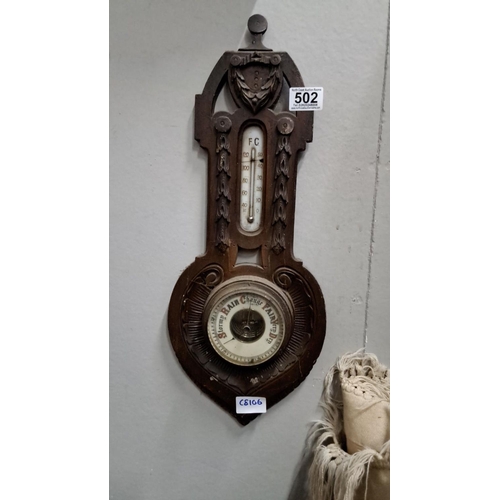 502 - Vintage wooden wall barometer and thermometer. It has carved detailing with 