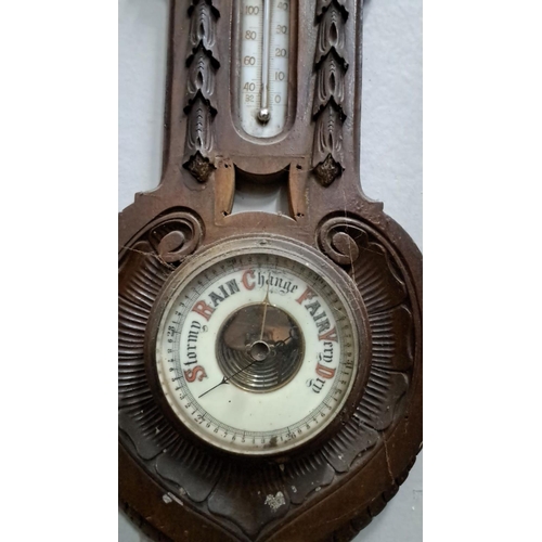 502 - Vintage wooden wall barometer and thermometer. It has carved detailing with 