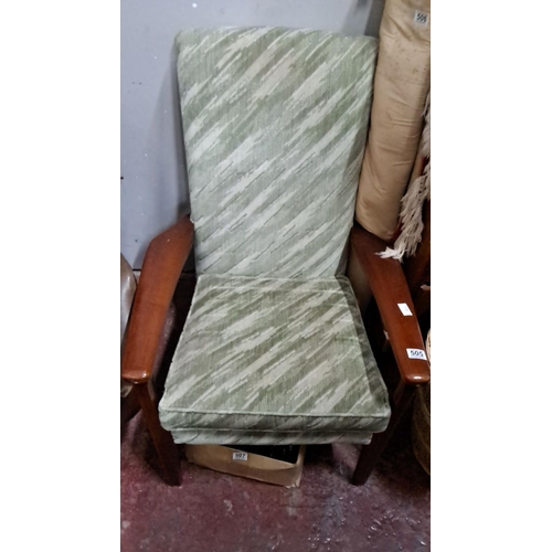 505 - Mid-Century Modern armchair with green patterned upholstery and solid wooden armrests. Condition is ... 