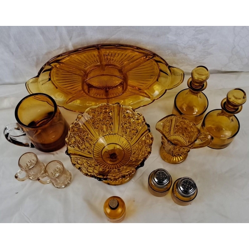 28 - A large collection of amber glassware comprising 14 pieces. It includes a tray, pitcher, bowl, two b... 