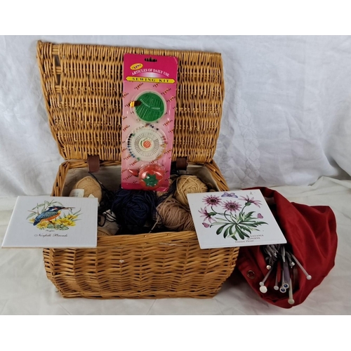 35 - Wicker sewing basket, sewing accessories, assorted yarns, knitting needles, and two botanical-themed... 