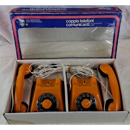 43 - This is a vintage set of two orange toy telephones. They are boxed and identified as 