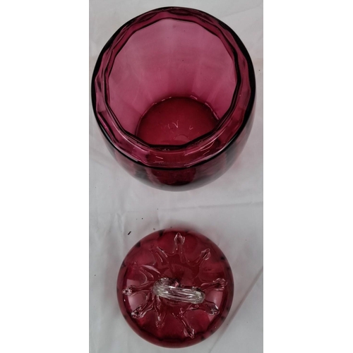 47 - Antique cranberry glass jar with a clear loop handle lid, featuring intricate relief details (lid a/... 