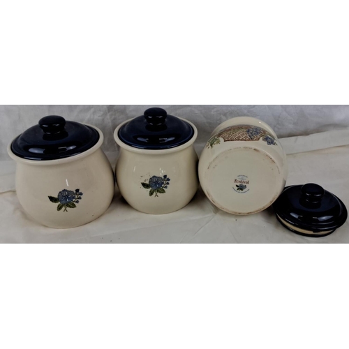 48 - Set of three ceramic kitchen canisters labeled Coffee, Sugar, and Tea. These items feature floral de... 