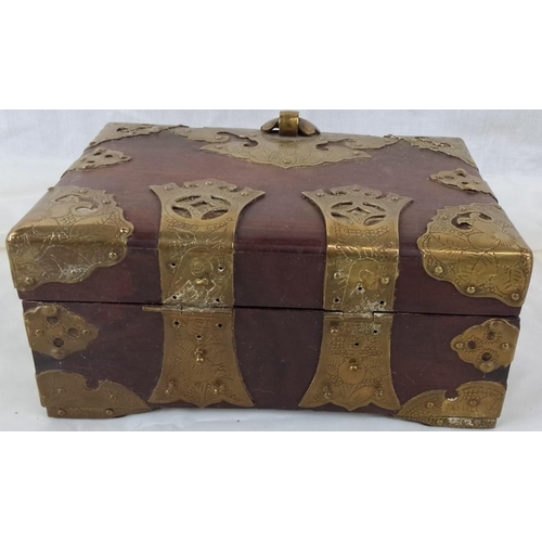 51 - Intricately embellished vintage wooden box with ornate brass detailing. The box features elaborate f... 