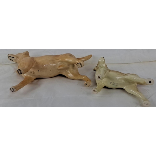 68 - Two ceramic dog figurines. One is marked 