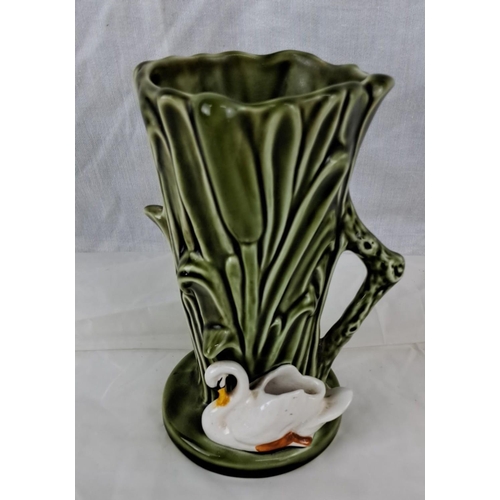 72 - A Sylvac ceramic vase featuring a swan. The vase has an embossed design and a green glaze. The model... 