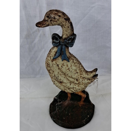 73 - Cast iron duck doorstop with painted detailing and blue bow accent.