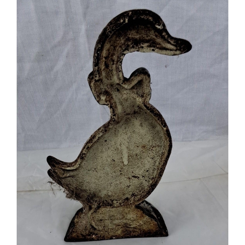 73 - Cast iron duck doorstop with painted detailing and blue bow accent.