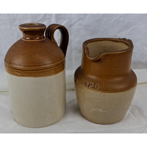 81 - Two small vintage stoneware jugs. One features a handle, is marked 