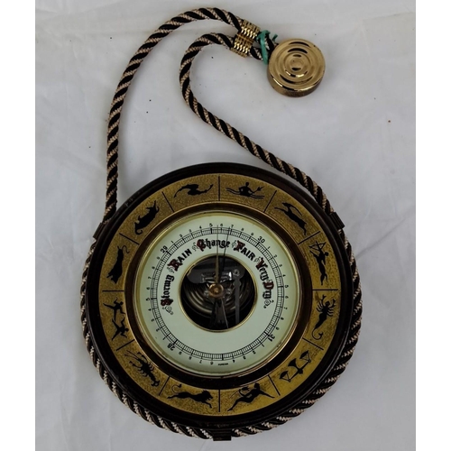 82 - A vintage hanging barometer made of brass and features zodiac symbols. It measures atmospheric press... 