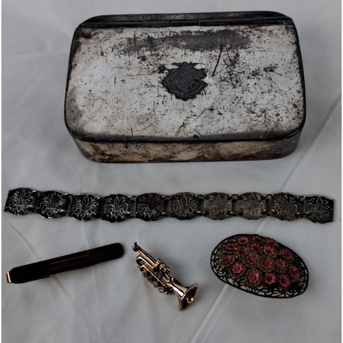 90 - This lot includes a vintage tin box, an ornate silver-tone bracelet, a gold-tone tie clip, a miniatu... 