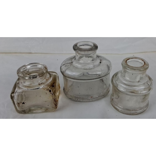 93 - Three vintage glass inkwells are included in the set, with a variety of shapes. One inkwell bears th... 