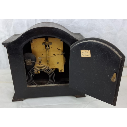 95 - Smiths Mantel Clock is dark wood case with intricate carvings. It features a Roman numeral face and ... 