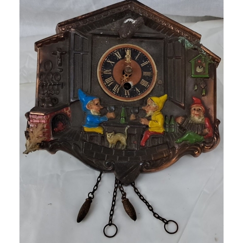 103 - Vintage cast iron wall clock features a whimsical painted gnome scene, Roman numeral clock face, and... 