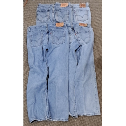 107 - This is a set of 5 vintage Levi's 501 jeans. They are light wash denim and feature classic back pock... 