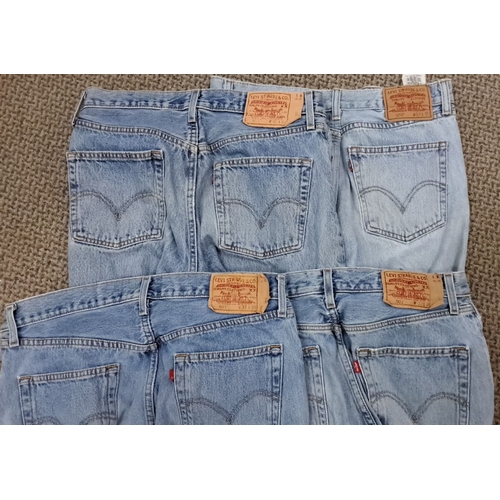 107 - This is a set of 5 vintage Levi's 501 jeans. They are light wash denim and feature classic back pock... 