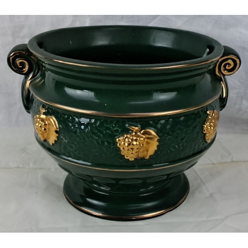 114 - Green ceramic jardinière with gold grapevine accents and decorative scroll handles. It features a te... 