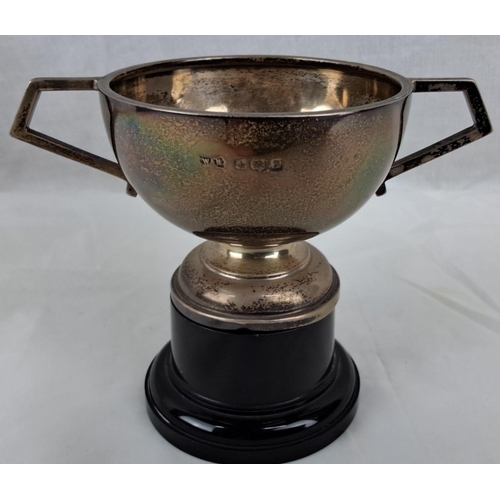 Silver-plated trophy cup with angular handles, mounted on a black base ...