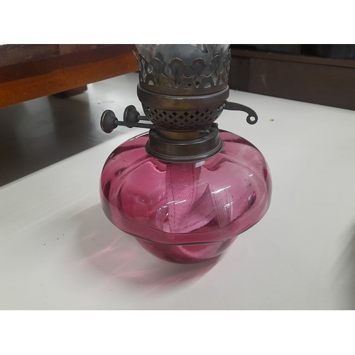 78 - A stunning antique ruby glass oil lamp with glass chimney.