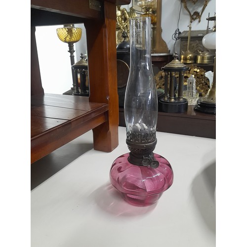 78 - A stunning antique ruby glass oil lamp with glass chimney.