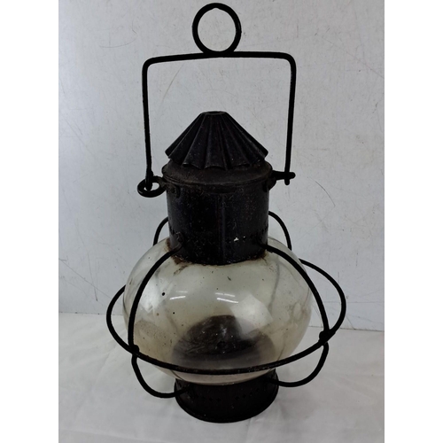 646 - Antique  Lantern with  globe and metal frame, featuring a handle for hanging.