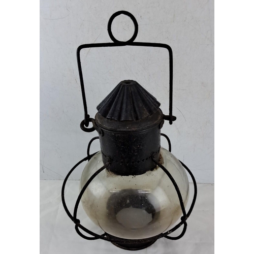 646 - Antique  Lantern with  globe and metal frame, featuring a handle for hanging.