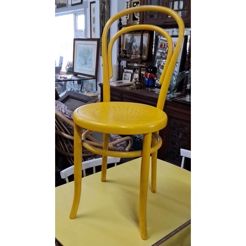 669 - Vintage yellow bentwood chair from the Mid-Century Modern period. Features a curved backrest and per... 