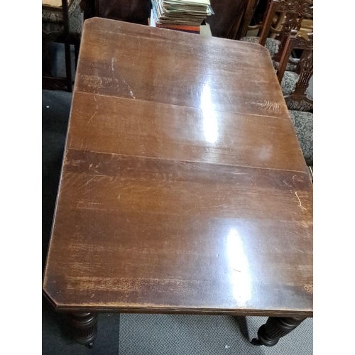 684 - This is an early 20th-century oak dining table with a rectangular top and intricately turned legs. T... 