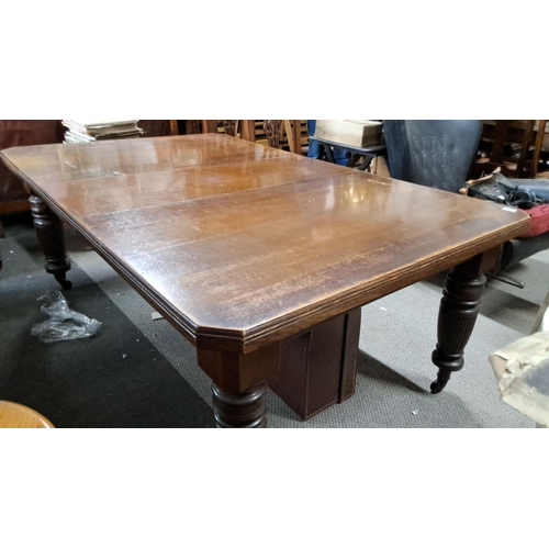 684 - This is an early 20th-century oak dining table with a rectangular top and intricately turned legs. T... 