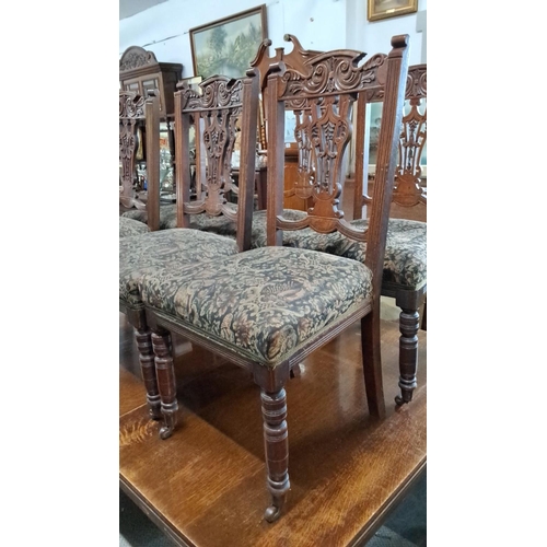 685 - Set of four Victorian carved oak dining chairs with upholstered seats. These chairs feature intricat... 