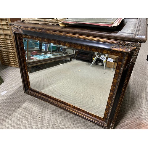 687 - Antique gilded wood-framed mirror with intricate carved floral details. From the Victorian period. T... 