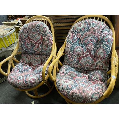 638 - A pair of upholstered bamboo framed conservatory/lounge chairs.