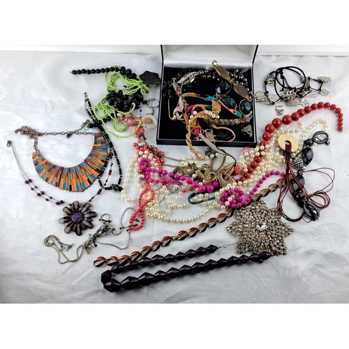 11 - Assorted collection of fashion jewelry includes necklaces, bracelets, and brooches in various materi... 