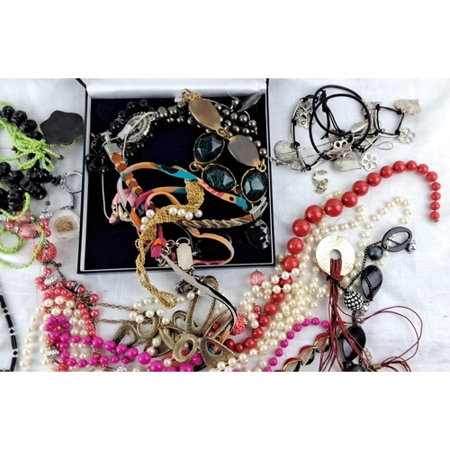 11 - Assorted collection of fashion jewelry includes necklaces, bracelets, and brooches in various materi... 