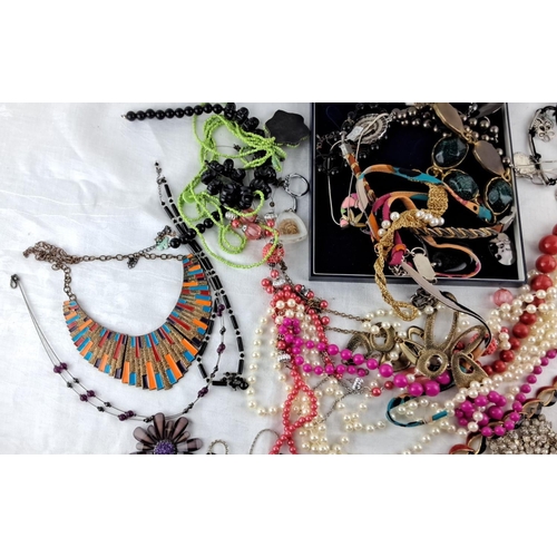 11 - Assorted collection of fashion jewelry includes necklaces, bracelets, and brooches in various materi... 