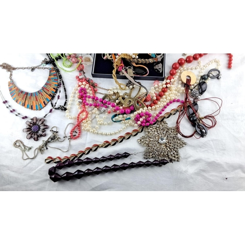 11 - Assorted collection of fashion jewelry includes necklaces, bracelets, and brooches in various materi... 