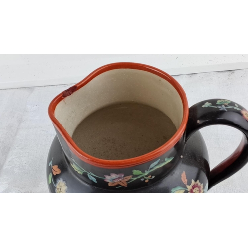 17 - Antique hand-painted ceramic pitcher with oriental figures and floral motifs, featuring a dark glaze... 