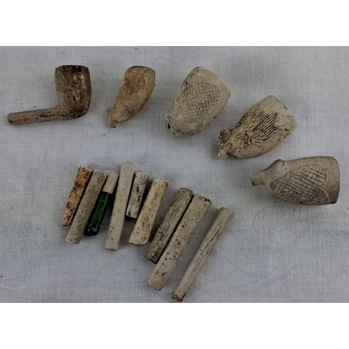 56 - Collection of antique clay tobacco pipes and stem fragments, including decorated bowls and partial s... 