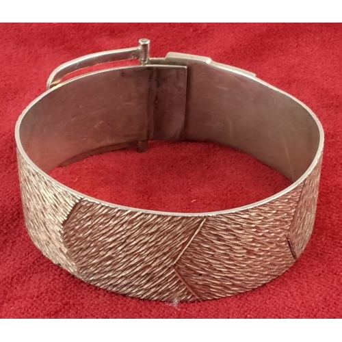 57 - Sterling Silver bracelet with textured band and buckle design.