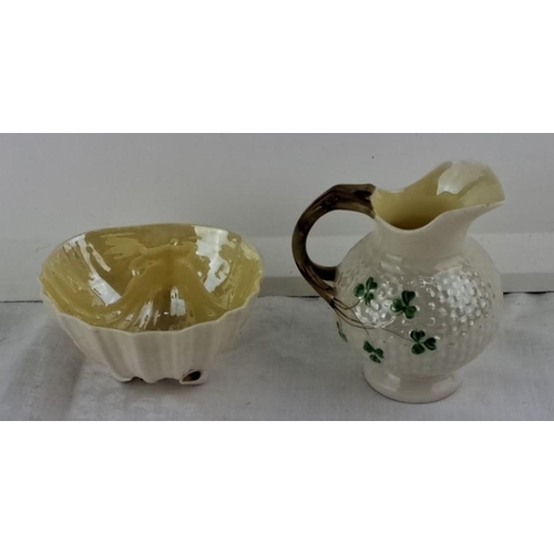 61 - Belleek porcelain jug with shamrock motif and a cream-colored scalloped bowl with gloss finish.