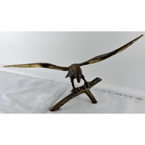 63 - large Brass eagle sculpture with wings outstretched, perched on a branch. Exquisite detailing on fea... 