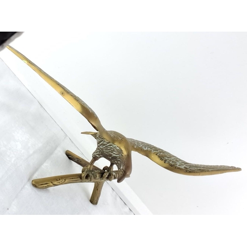 63 - large Brass eagle sculpture with wings outstretched, perched on a branch. Exquisite detailing on fea... 